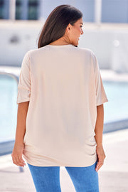 Tan ribbed batwing cardigan with draped front detail.