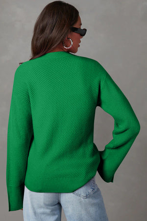 Green knit sweater with textured pattern and slit sleeves, crew neck, long sleeves.