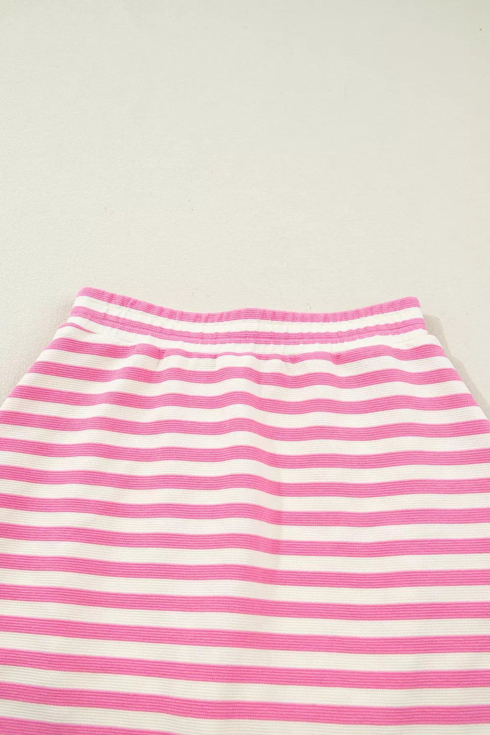 Pink and white striped bikini bottoms with an elastic waistband.