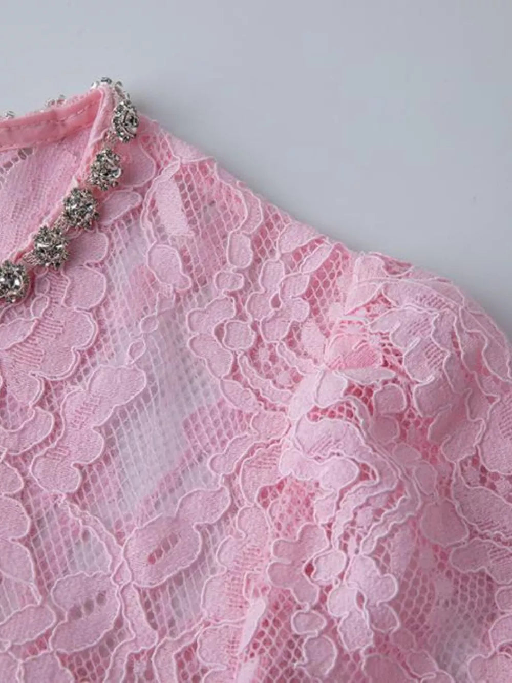 Pink lace midi dress with sheer sleeves and jeweled neckline detail