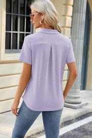 Lavender textured polo shirt with short sleeves and a V-neck detail.
