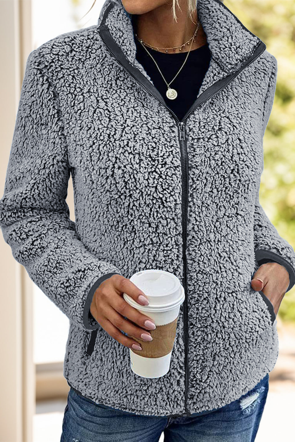 Teddy fleece zip-up jacket in dark gray with a stand-up collar and zippered pockets.