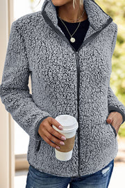 Teddy fleece zip-up jacket in dark gray with a stand-up collar and zippered pockets.