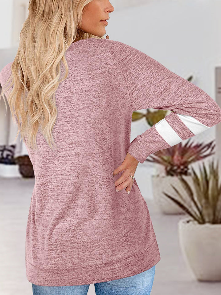 Dusty pink heathered raglan v-neck top with white varsity stripes on the sleeves.