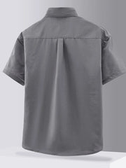 Grey short sleeve button-down shirt with back pleats and collar detail