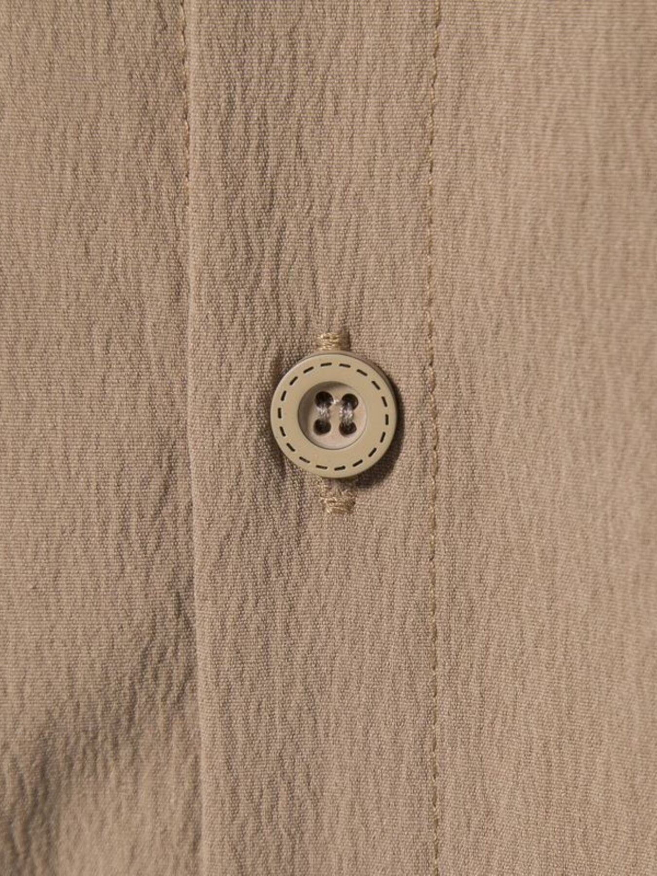 Men's plus-size beige button-up shirt with textured fabric and a round button detail.