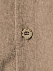 Men's plus-size beige button-up shirt with textured fabric and a round button detail.