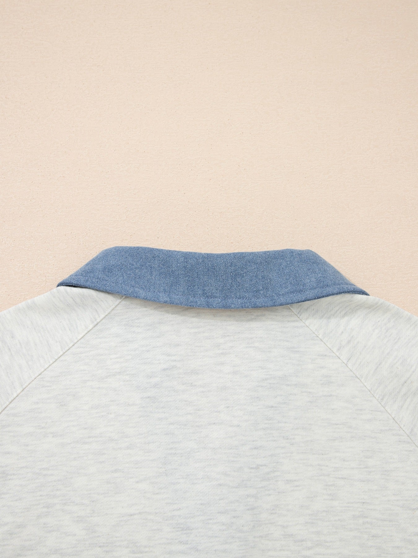 Heathered casual top with blue denim collar and raglan sleeves.