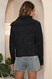 Black textured knit sweater with asymmetric collar and lettuce hem detail