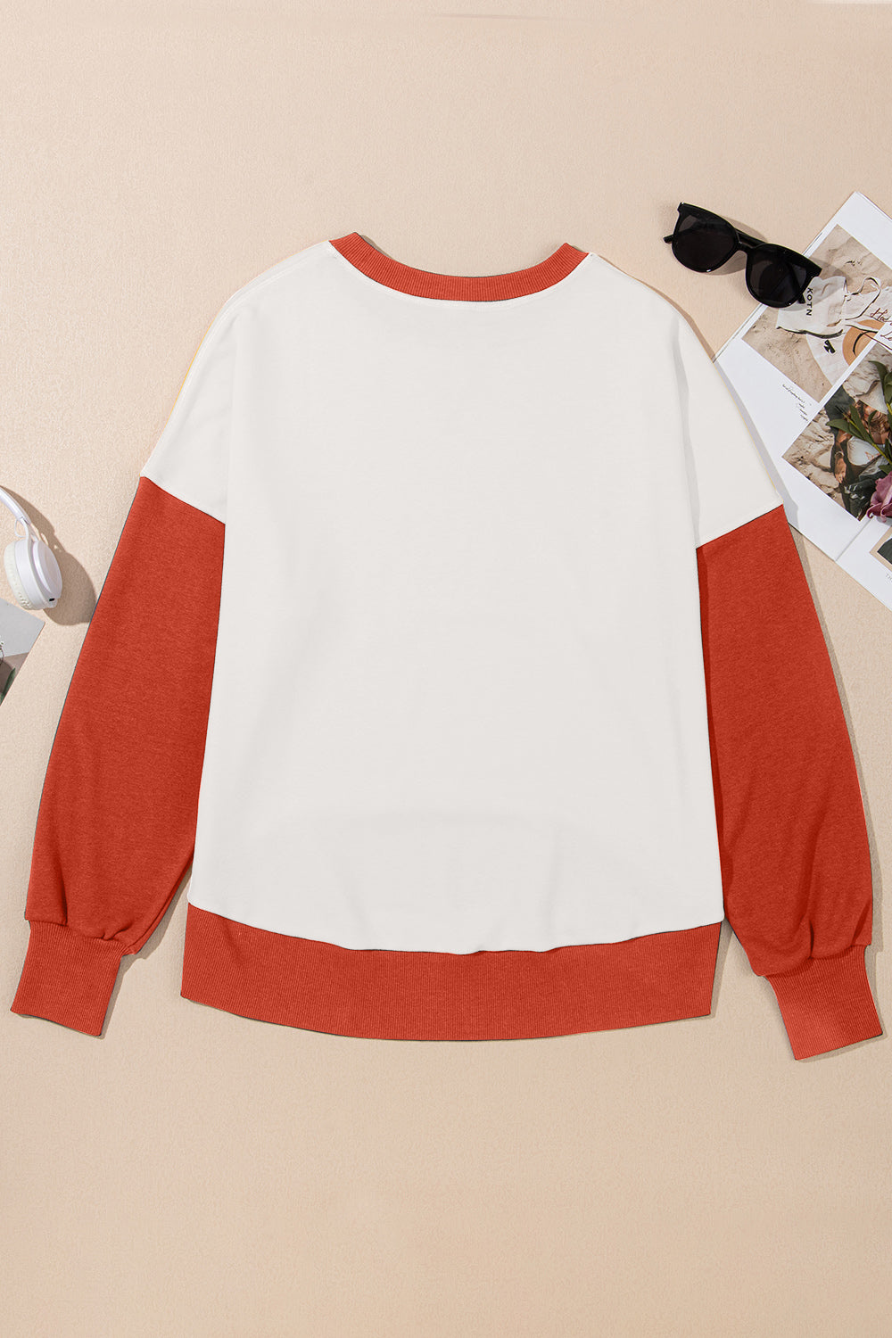Chic Contrast Crewneck Sweatshirt in white with rust orange sleeves and hem.