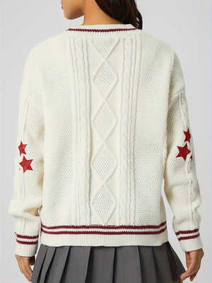 White cable knit cardigan with red stars and striped trim.