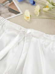 White satin lounge shorts with drawstring and lace trim detail