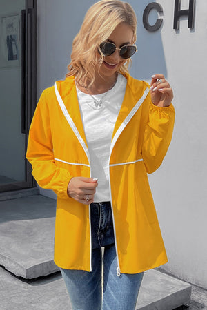 Gold hooded rain jacket with white trim and zipper, featuring a casual, waterproof design.