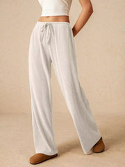 White ribbed wide-leg drawstring pants with a relaxed fit.