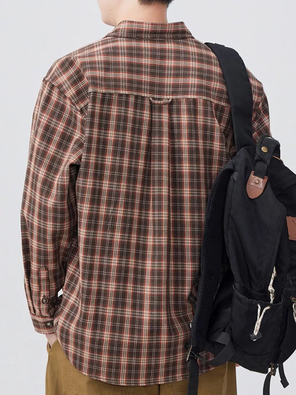 Men's brown plaid long sleeve button-down shirt with buttoned cuffs.