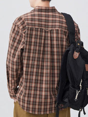 Men's brown plaid long sleeve button-down shirt with buttoned cuffs.