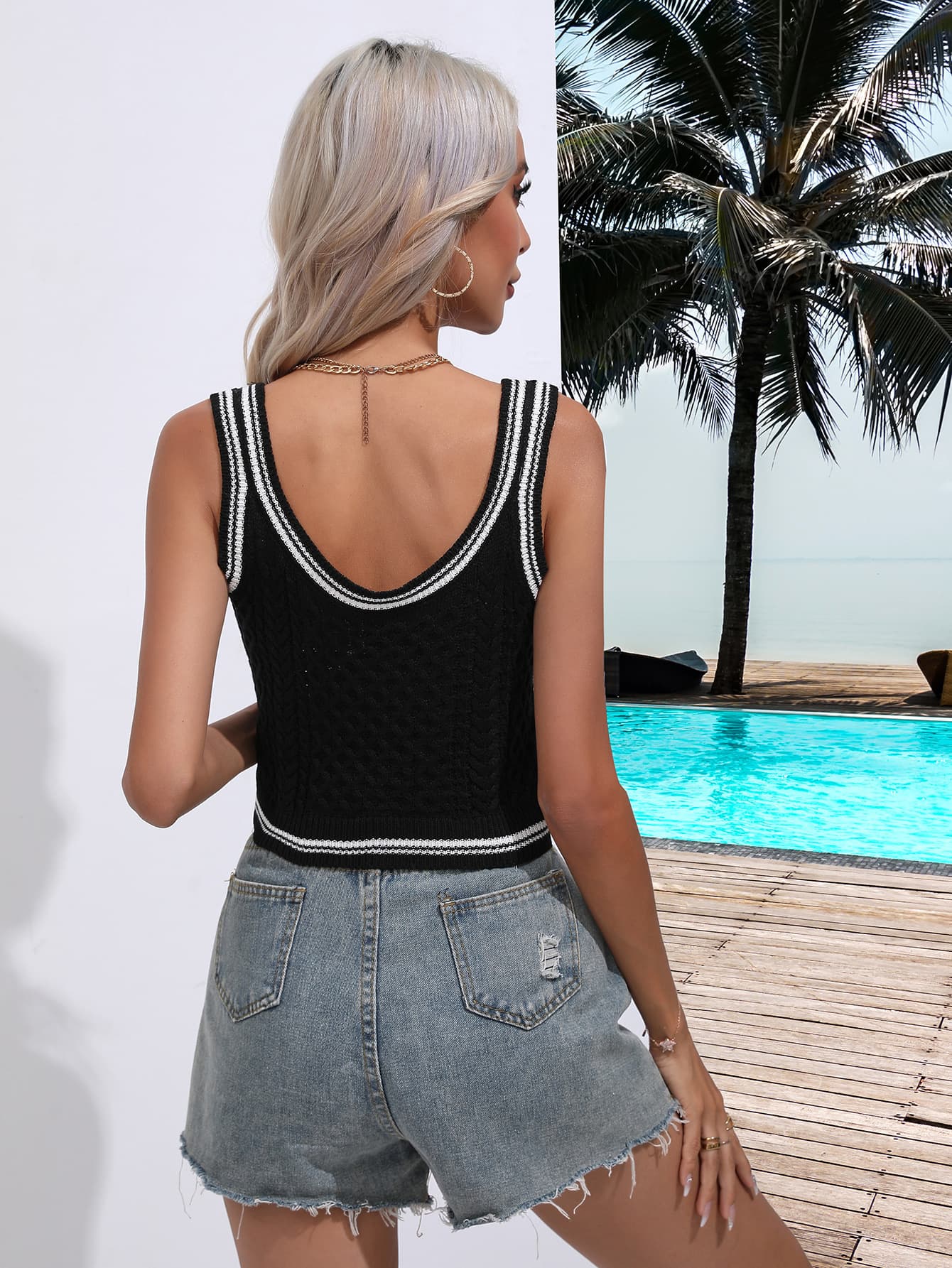 Black scoop knit tank top with white trim and cable knit detail.