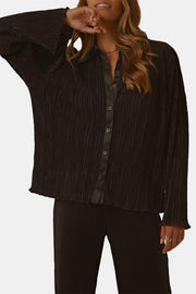 Black pleated shirt with satin collar and wide-leg trousers set.