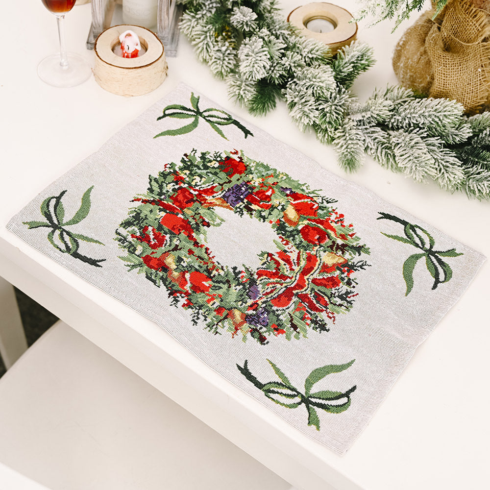 Embroidered Christmas placemat with a festive wreath and bows, available in Santa, Wreath, Tree, or Reindeer colors.