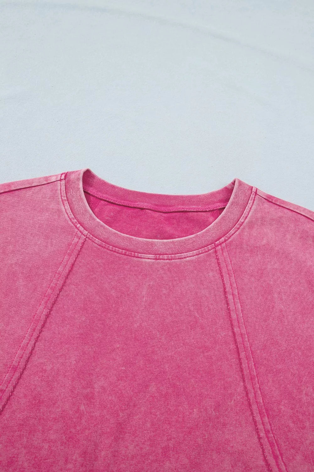 Pink mineral wash t-shirt with cap sleeves and contrast stitching detail.