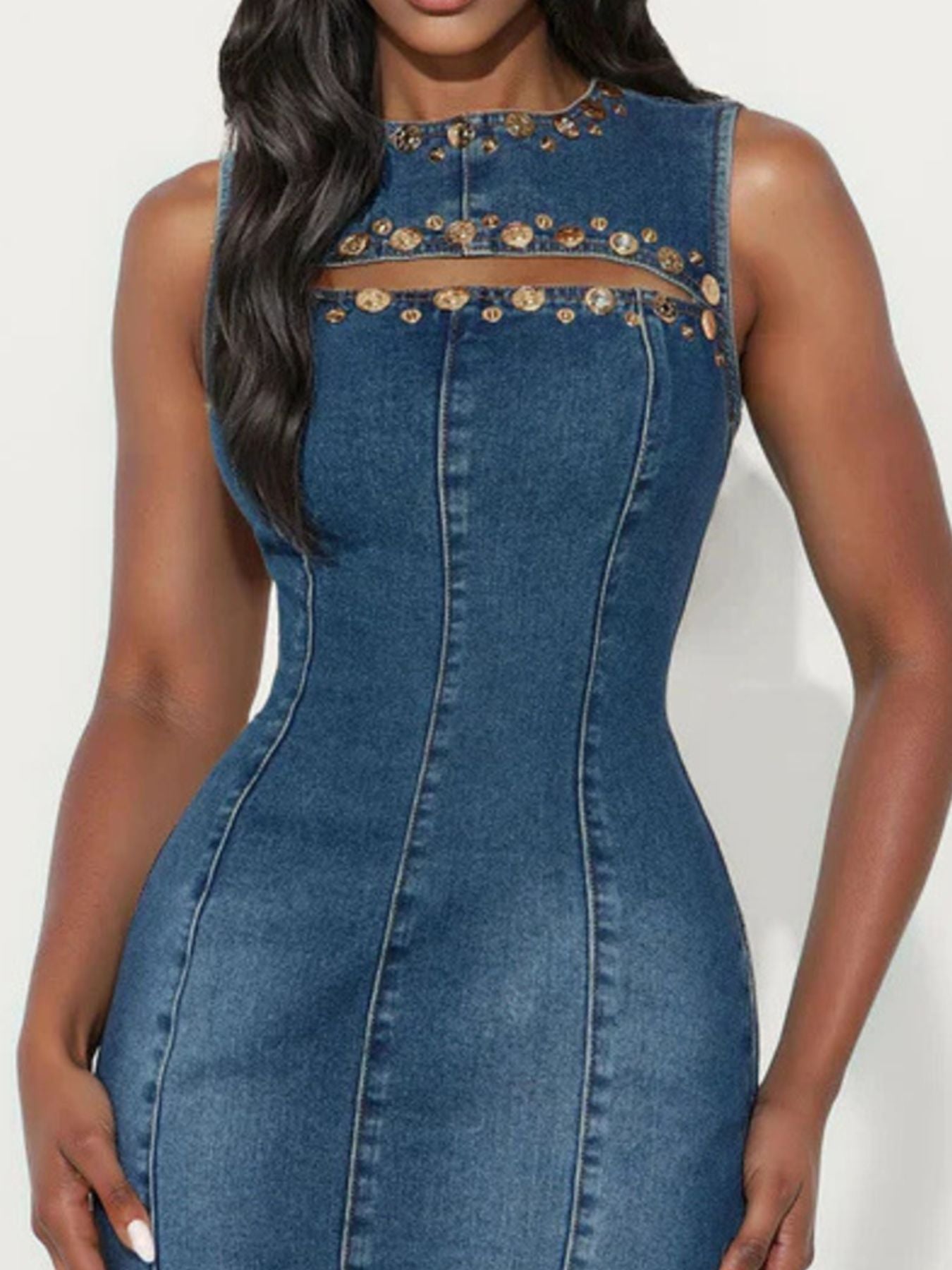 Embellished denim bodycon dress with cutout detail and gold accents.