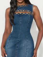 Embellished denim bodycon dress with cutout detail and gold accents.