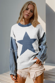 White knit sweater with denim sleeves, featuring a large blue starburst.