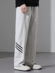 Light Flower Gray sweatpants with black stripes on the left leg, loose fit.