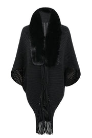 Black knit cape with faux fur collar and fringe detail