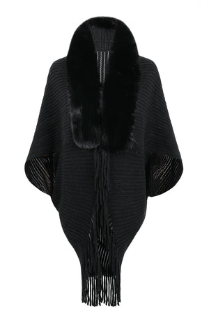 Black knit cape with faux fur collar and fringe detail