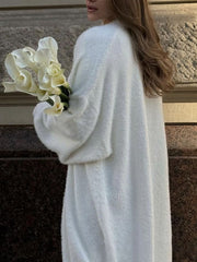 White plush maxi cardigan with balloon sleeves and a soft texture.