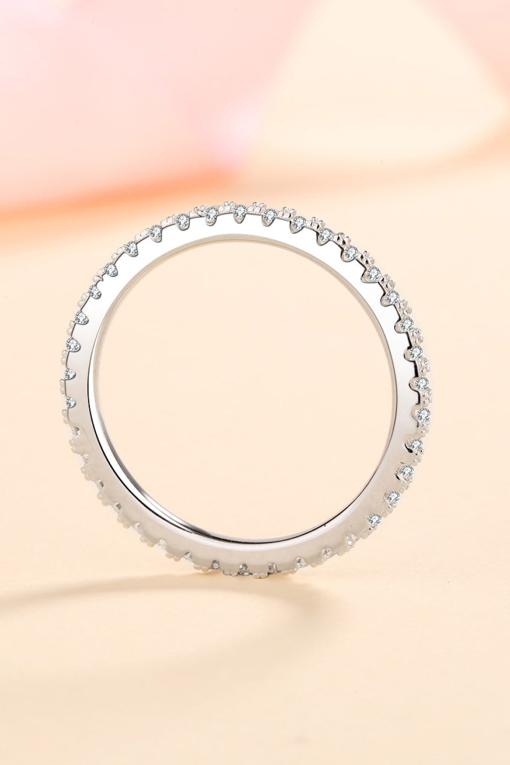 Sterling silver eternity band ring with micro-pave set cubic zirconia stones.