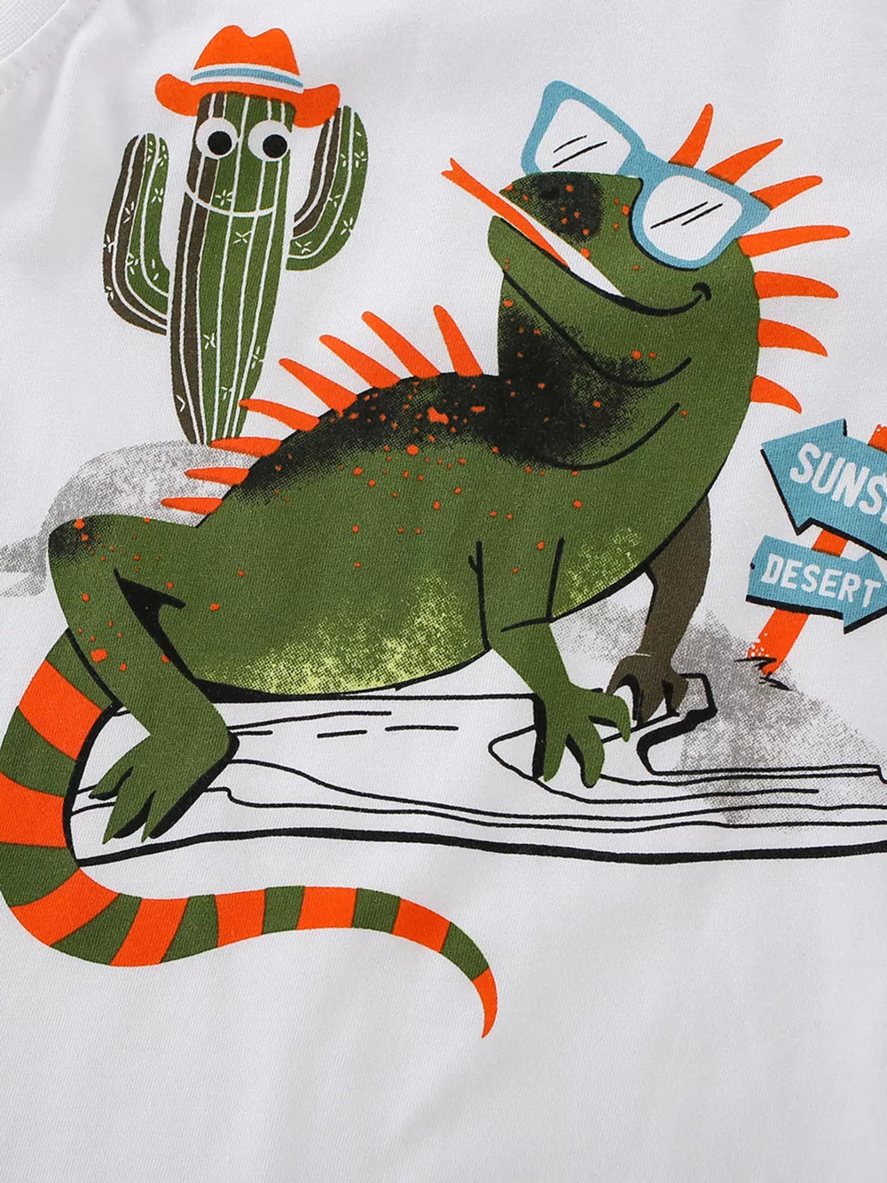 Toddler white cotton graphic tee with green lizard, cactus, and desert signs.