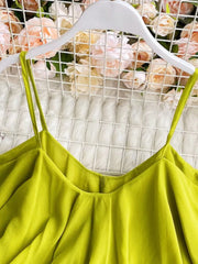 Light green camisole with spaghetti straps and delicate ruffles.