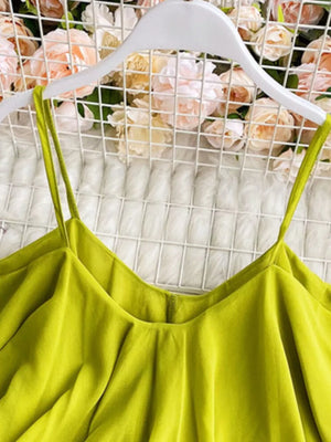 Light green camisole with spaghetti straps and delicate ruffles.