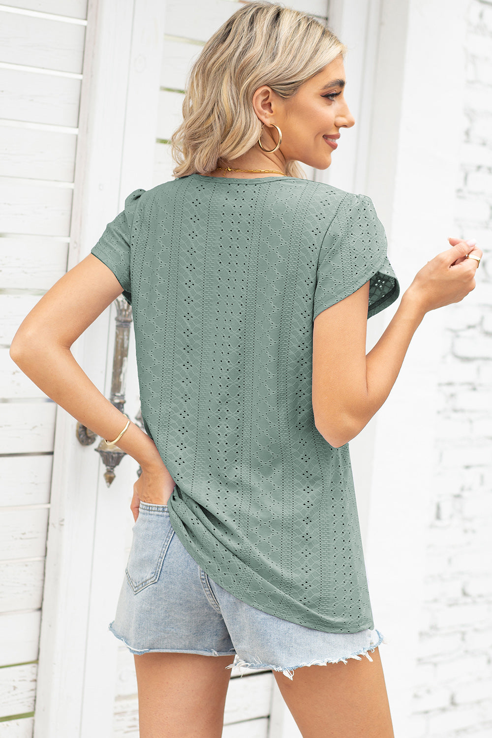 Sage eyelet flutter sleeve top with a textured pattern.