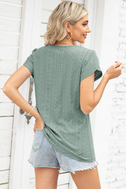 Sage eyelet flutter sleeve top with a textured pattern.