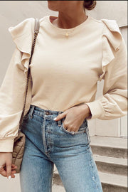 Cream sweatshirt with ruffled shoulders and ribbed cuffs