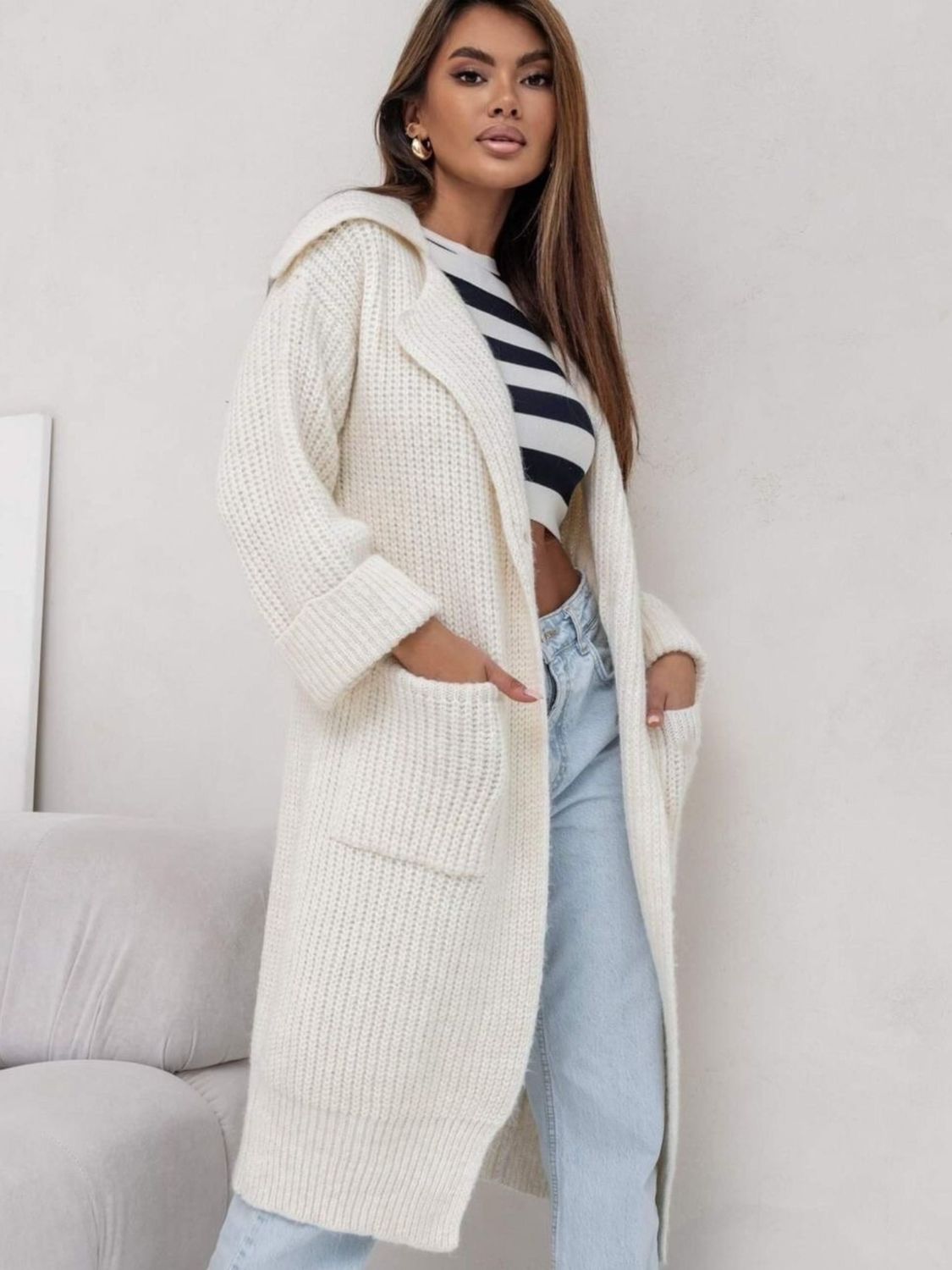 Cream oversized knit lapel cardigan with pockets and cuffed sleeves.