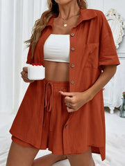 Orange linen shirt and shorts set with drawstring waist and button front.