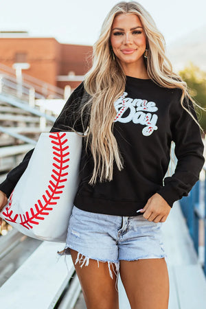 Black sweatshirt with white baseball script appliqué and red stitching detail.