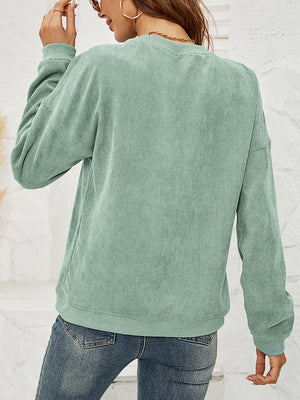 Light Green corduroy crewneck sweatshirt with lip print detail and long sleeves.