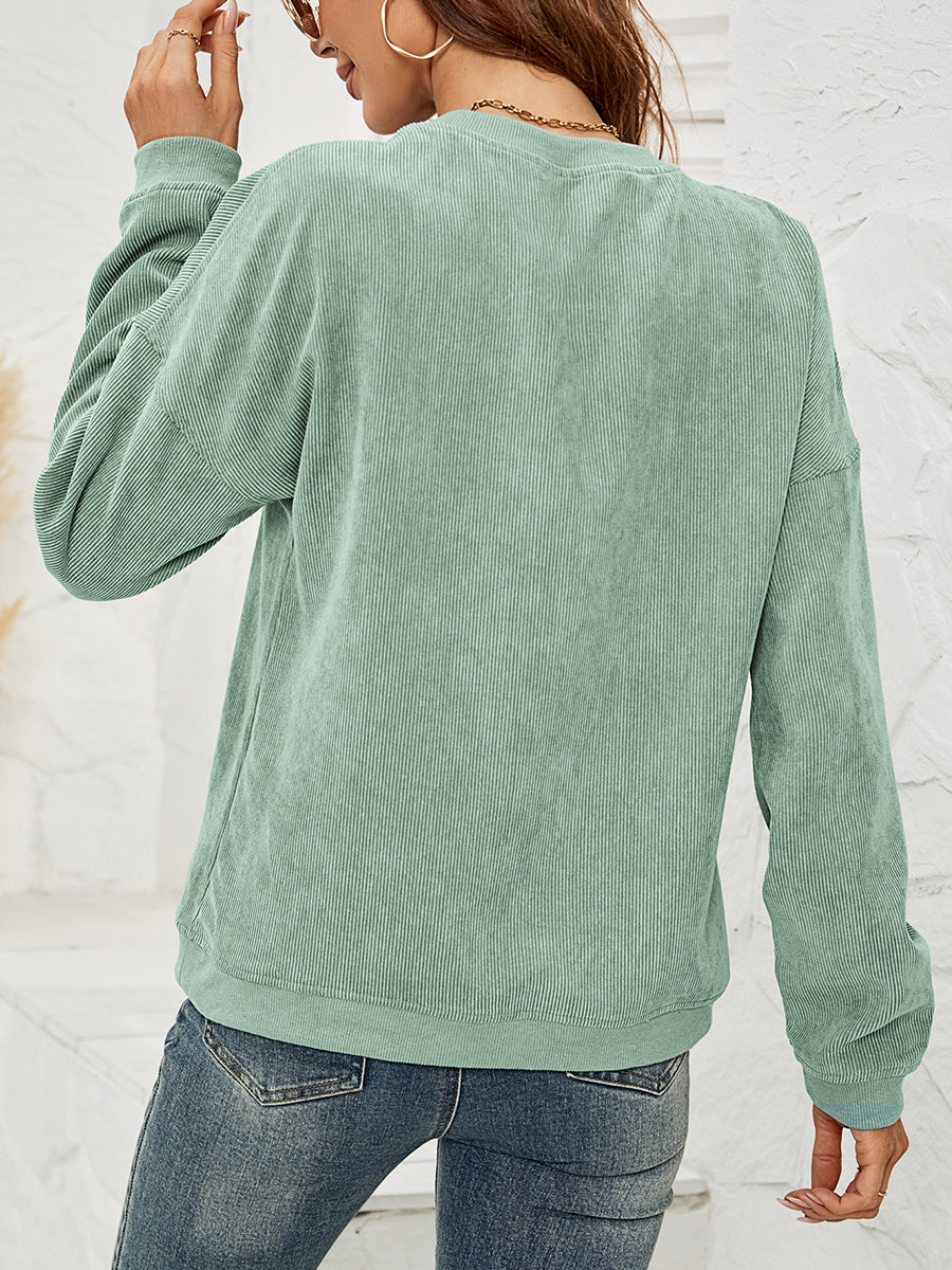 Light Green corduroy crewneck sweatshirt with lip print detail and long sleeves.