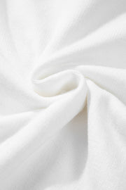 White knit sweater with drop shoulder detail, showing fabric texture.