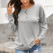 Gray henley sweatshirt with drop shoulders and button placket.