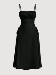Black cami dress with ruched bodice, A-line skirt and crisscross lace-up sides.