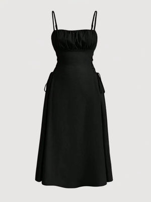 Black cami dress with ruched bodice, A-line skirt and crisscross lace-up sides.