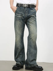 Vintage wash flare leg jeans in medium blue denim with distressed details and angled pockets.