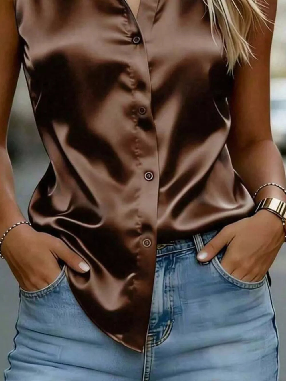 Luxurious satin sleeveless button-up shirt in dark brown with a curved hem.