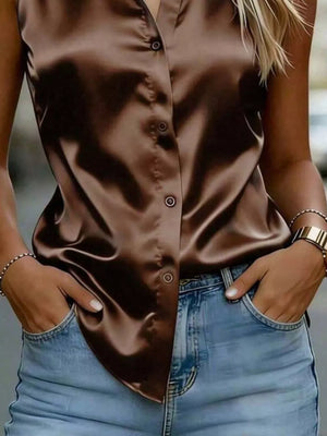 Luxurious satin sleeveless button-up shirt in dark brown with a curved hem.